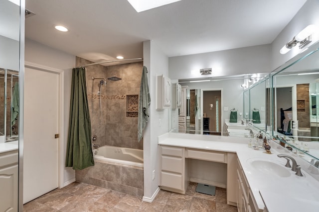 2313 Parkhaven Dr, Plano, TX 75075 - full bathroom with tiled shower / bath, vanity, recessed lighting, and a skylight