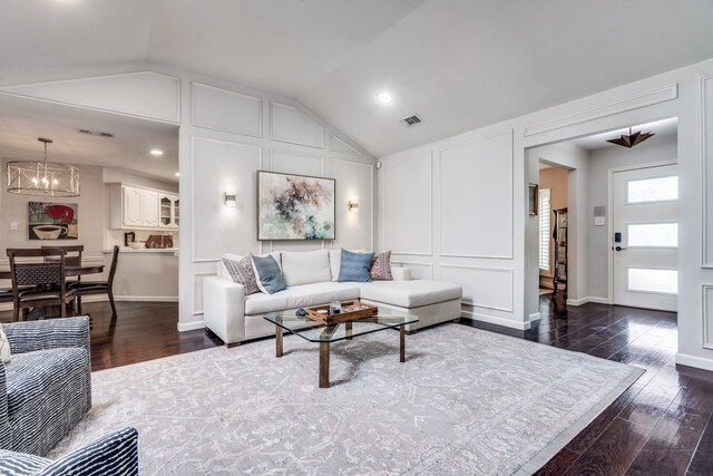 2313 Parkhaven Dr, Plano, TX 75075 - living room with a chandelier, dark wood finished floors, a decorative wall, and vaulted ceiling