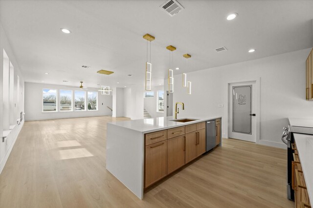 3434 Puget St, Dallas, TX 75212 - kitchen with appliances with stainless steel finishes, light wood-type flooring, open floor plan, a kitchen island with sink, and light countertops