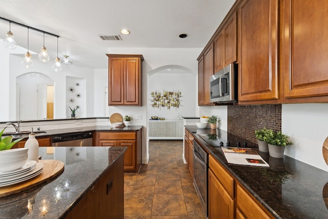 5312 Ridgeson Dr, Mckinney, TX 75071 - kitchen with stainless steel appliances, arched walkways, backsplash, stone finish floors, and recessed lighting