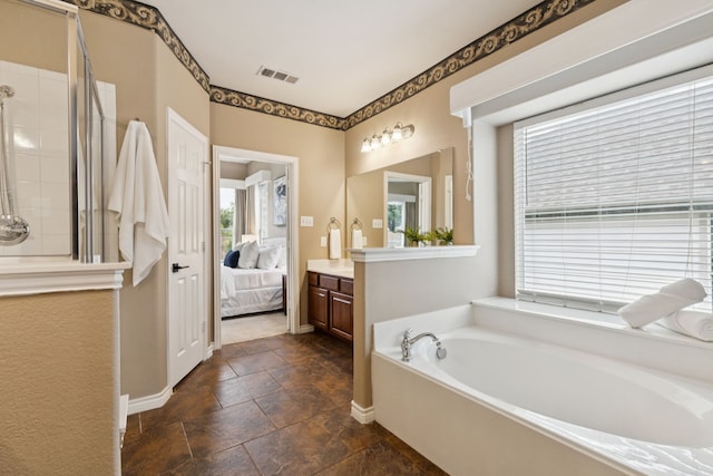 5312 Ridgeson Dr, Mckinney, TX 75071 - ensuite bathroom featuring healthy amount of natural light, vanity, a garden tub, and a shower stall