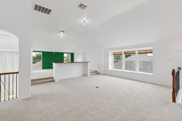 5312 Ridgeson Dr, Mckinney, TX 75071 - spare room featuring carpet floors, healthy amount of natural light, arched walkways, and vaulted ceiling