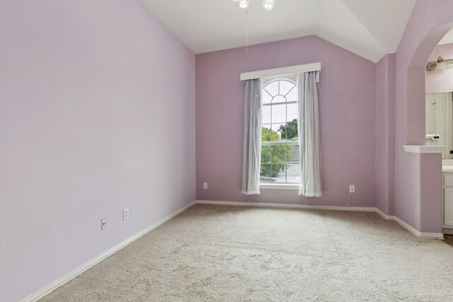 5312 Ridgeson Dr, Mckinney, TX 75071 - empty room featuring carpet flooring, arched walkways, and lofted ceiling