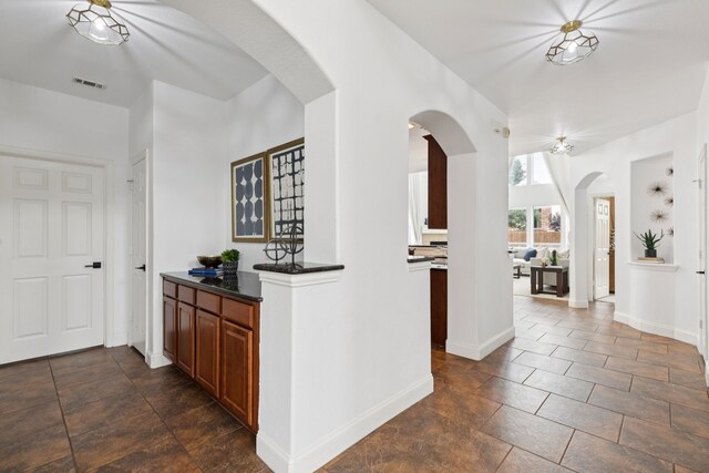 5312 Ridgeson Dr, Mckinney, TX 75071 - hall with arched walkways and baseboards