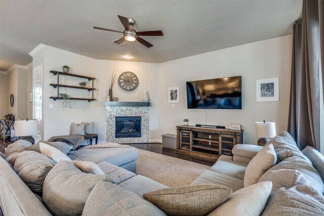 905 Crystal Oak Ln, Arlington, TX 76005 - living area featuring ceiling fan, wood finished floors, a tiled fireplace, and ornamental molding