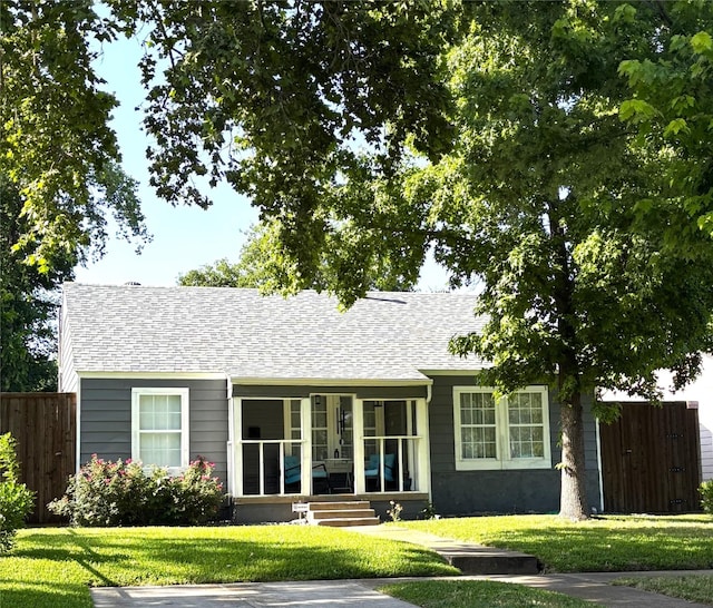 4204 Geddes Ave, Fort Worth, TX 76107 - rear view of house with a shingled roof and a sunroom