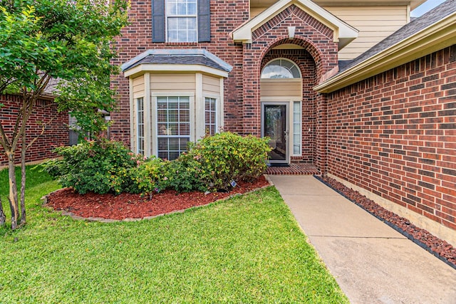1617 Wood Ridge Ct, Corinth, TX 76210 - doorway to property featuring brick siding, a yard, and a shingled roof