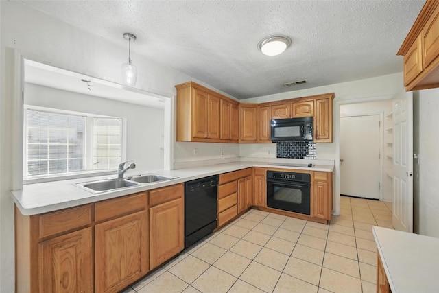 2015 Shenandoah Dr, Carrollton, TX 75007 - kitchen featuring black appliances, light countertops, a textured ceiling, light tile patterned floors, and hanging light fixtures