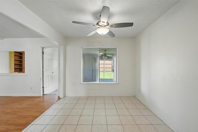 2015 Shenandoah Dr, Carrollton, TX 75007 - unfurnished room with a textured ceiling, a ceiling fan, and light wood-type flooring