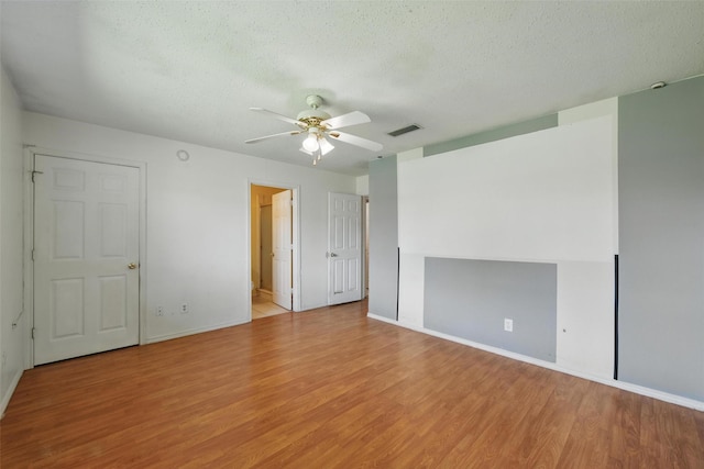 2015 Shenandoah Dr, Carrollton, TX 75007 - spare room with ceiling fan, light wood-style floors, and a textured ceiling