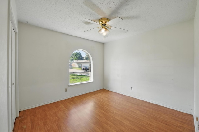 2015 Shenandoah Dr, Carrollton, TX 75007 - empty room with a ceiling fan, wood finished floors, and a textured ceiling