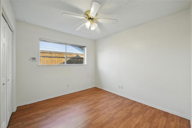 2015 Shenandoah Dr, Carrollton, TX 75007 - unfurnished bedroom with wood finished floors, a closet, and a ceiling fan