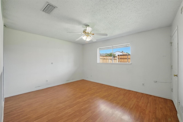 2015 Shenandoah Dr, Carrollton, TX 75007 - unfurnished room with wood finished floors, ceiling fan, and a textured ceiling