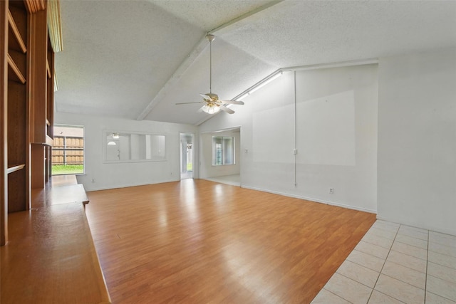 2015 Shenandoah Dr, Carrollton, TX 75007 - unfurnished living room with ceiling fan, lofted ceiling, wood finished floors, and a textured ceiling