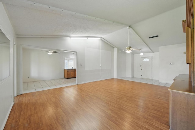 2015 Shenandoah Dr, Carrollton, TX 75007 - unfurnished living room featuring ceiling fan, light wood-style floors, and lofted ceiling