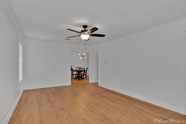 208 Arthur Ave, Shreveport, LA 71105 - spare room featuring a ceiling fan, light wood-style floors, crown molding, and a chandelier