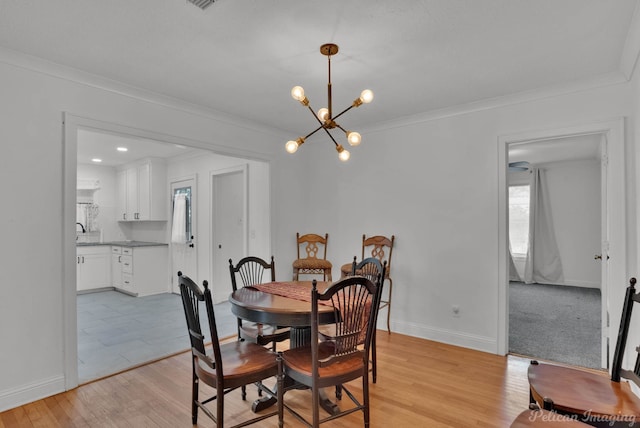 208 Arthur Ave, Shreveport, LA 71105 - dining room with a chandelier, light wood-type flooring, and crown molding