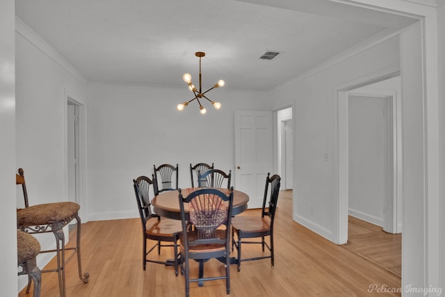 208 Arthur Ave, Shreveport, LA 71105 - dining room featuring a chandelier, crown molding, and light wood-type flooring