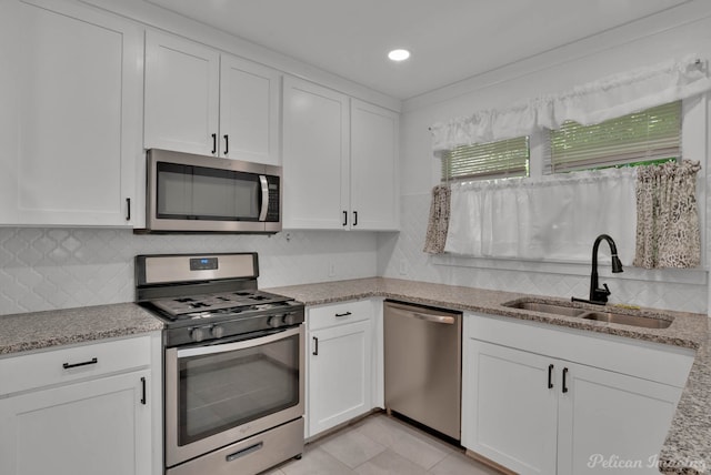 208 Arthur Ave, Shreveport, LA 71105 - kitchen with appliances with stainless steel finishes, white cabinetry, decorative backsplash, light stone countertops, and recessed lighting
