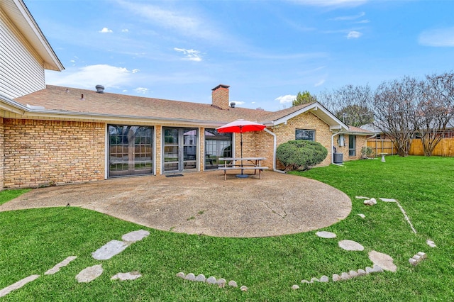 1632 Andy Dr, Sherman, TX 75092 - back of house featuring a patio, brick siding, a chimney, and roof with shingles