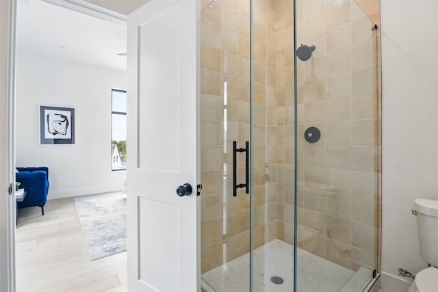 430 E 8th Unit 101, Dallas, TX 75203 - bathroom featuring a shower stall and wood finished floors