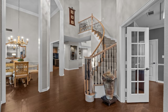5820 Woodwind Dr, Plano, TX 75093 - entryway featuring a chandelier, wood finished floors, crown molding, stairway, and a towering ceiling