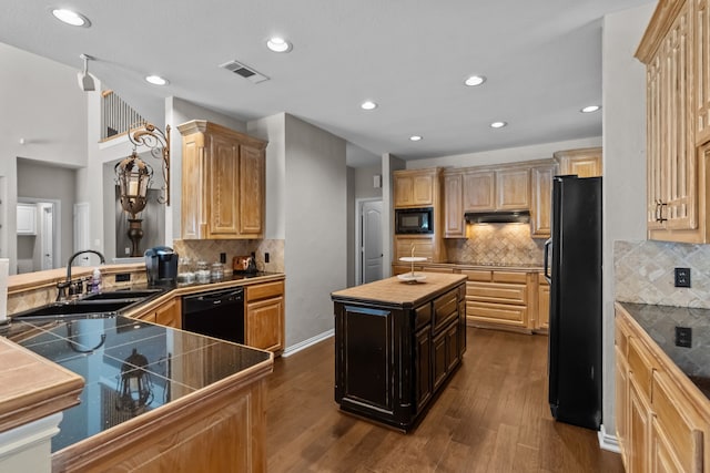 5820 Woodwind Dr, Plano, TX 75093 - kitchen with black appliances, under cabinet range hood, dark wood-style floors, tasteful backsplash, and light brown cabinetry