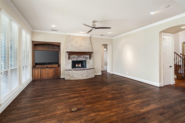 11560 Mirage Ln, Frisco, TX 75033 - unfurnished living room featuring arched walkways, a ceiling fan, wood finished floors, a fireplace, and ornamental molding