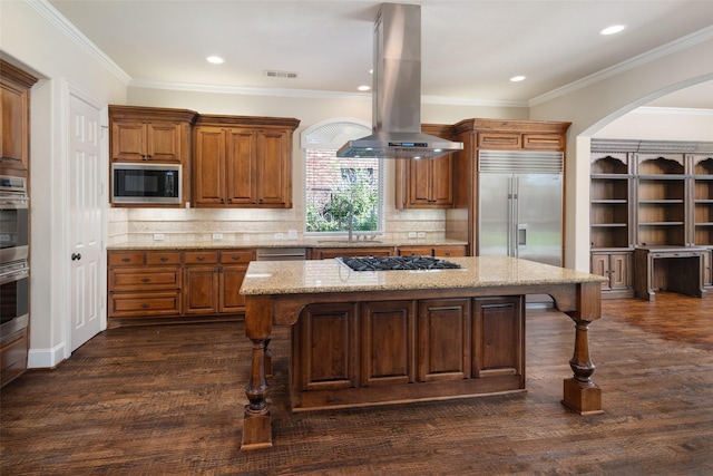11560 Mirage Ln, Frisco, TX 75033 - kitchen with island range hood, built in appliances, a breakfast bar, a center island, and light stone counters