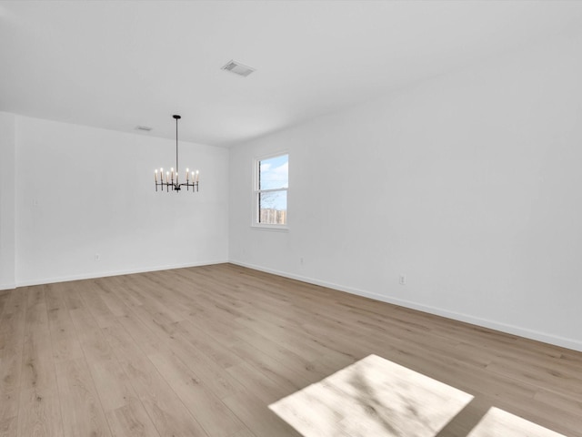 9741 Indian Canyon Dr, Plano, TX 75025 - spare room featuring a chandelier and light wood-style floors