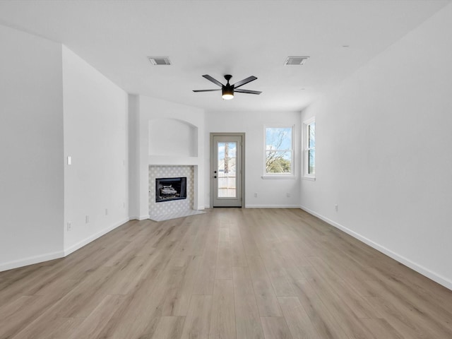 9741 Indian Canyon Dr, Plano, TX 75025 - unfurnished living room with a fireplace, ceiling fan, and light wood-style flooring