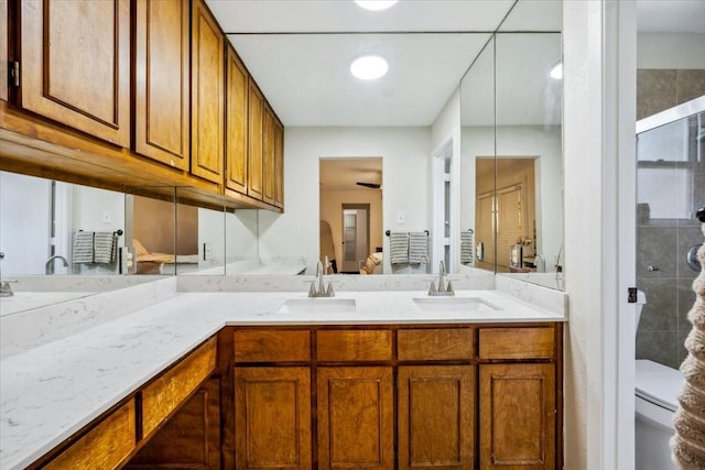7920 Donegal Ln, North Richland Hills, TX 76180 - bathroom with ensuite bath, double vanity, a shower stall, and ceiling fan