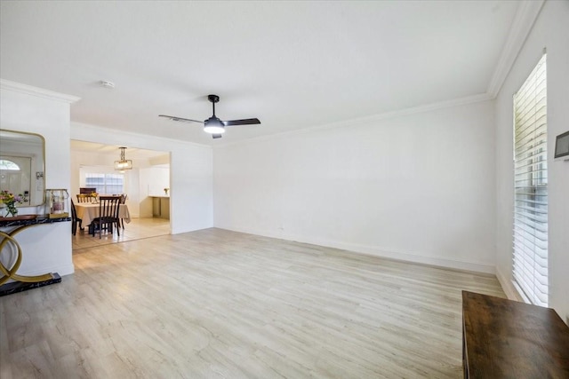 7920 Donegal Ln, North Richland Hills, TX 76180 - unfurnished living room featuring light wood-style floors, a ceiling fan, crown molding, and a chandelier