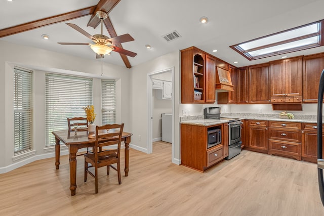2305 Delmar Dr, Plano, TX 75075 - kitchen with stainless steel appliances, premium range hood, light wood finished floors, and brown cabinetry