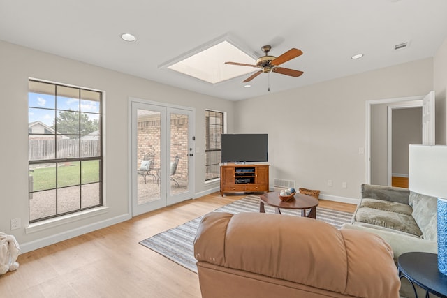 2305 Delmar Dr, Plano, TX 75075 - living area featuring light wood finished floors, a ceiling fan, a skylight, and recessed lighting