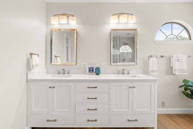 2305 Delmar Dr, Plano, TX 75075 - full bath featuring double vanity, a shower with door, and wood finished floors