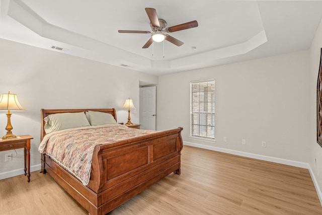 2305 Delmar Dr, Plano, TX 75075 - bedroom featuring a tray ceiling, light wood-type flooring, and a ceiling fan