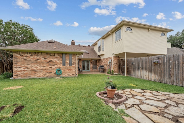 2305 Delmar Dr, Plano, TX 75075 - back of house with a fenced backyard, brick siding, a patio area, and a shingled roof