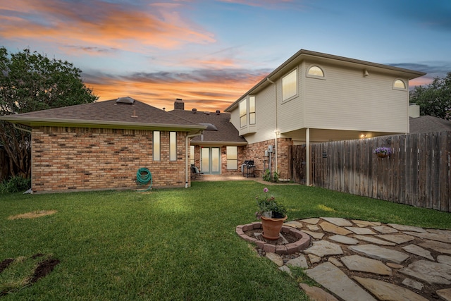2305 Delmar Dr, Plano, TX 75075 - back of property featuring brick siding, a patio area, and a shingled roof