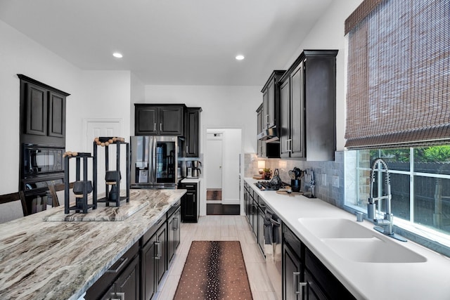 1809 Lake Glen Trl, Mansfield, TX 76063 - kitchen featuring black appliances, backsplash, recessed lighting, dark cabinets, and light stone countertops