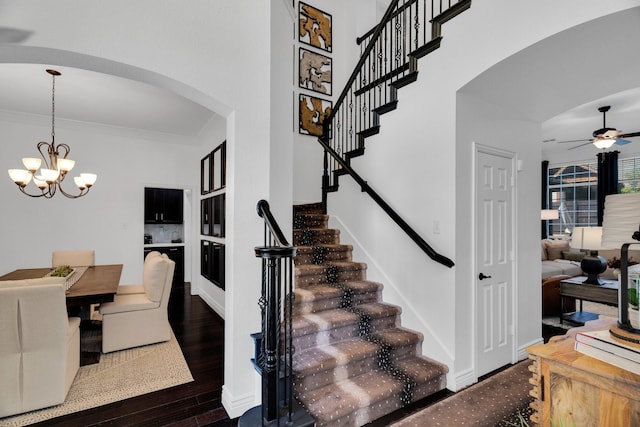1809 Lake Glen Trl, Mansfield, TX 76063 - stairway with arched walkways, crown molding, ceiling fan, wood finished floors, and a chandelier