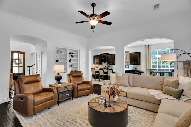 1809 Lake Glen Trl, Mansfield, TX 76063 - living area with arched walkways, ceiling fan, crown molding, light wood-style floors, and built in features