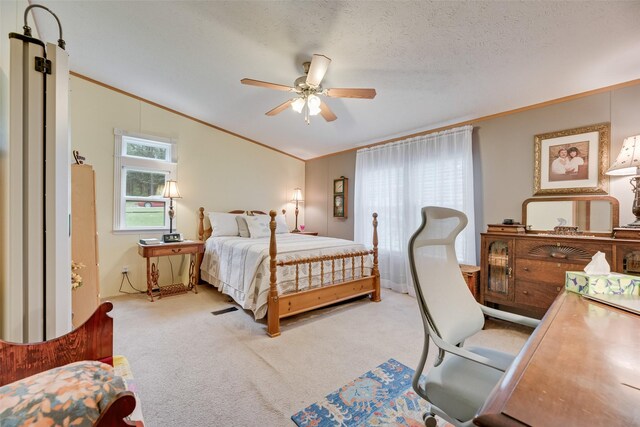 200 Dogwood Trl, Murchison, TX 75778 - bedroom with ornamental molding, lofted ceiling, carpet floors, ceiling fan, and a textured ceiling