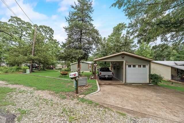 200 Dogwood Trl, Murchison, TX 75778 - view of green lawn with driveway and a garage