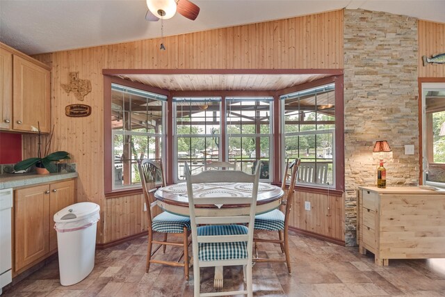 200 Dogwood Trl, Murchison, TX 75778 - dining room with lofted ceiling, a ceiling fan, wood walls, and stone finish flooring