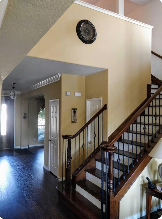 4924 Marsh Harrier Ave, Grand Prairie, TX 75052 - stairs featuring arched walkways, wood finished floors, and ornamental molding