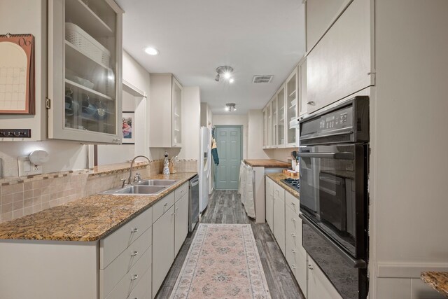 1218 Ridgeway Dr, Richardson, TX 75080 - kitchen with black oven, dishwasher, wood finished floors, backsplash, and a warming drawer
