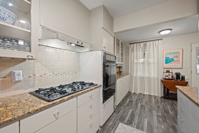 1218 Ridgeway Dr, Richardson, TX 75080 - kitchen featuring a warming drawer, black appliances, dark wood-style flooring, glass insert cabinets, and decorative backsplash