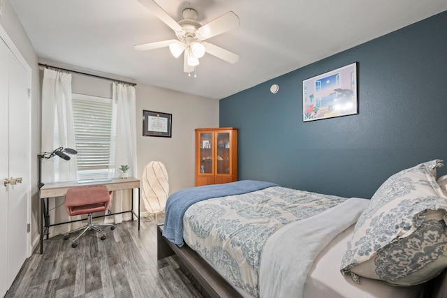 1218 Ridgeway Dr, Richardson, TX 75080 - bedroom featuring wood finished floors, a ceiling fan, and an office area