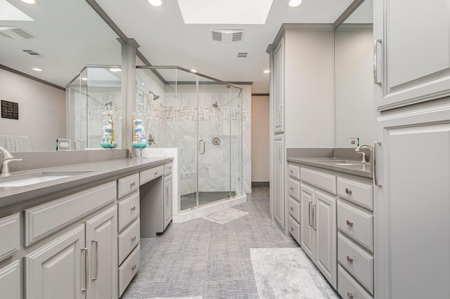 6141 Prestondell Ct, Dallas, TX 75240 - full bath with two vanities, a stall shower, recessed lighting, and a skylight